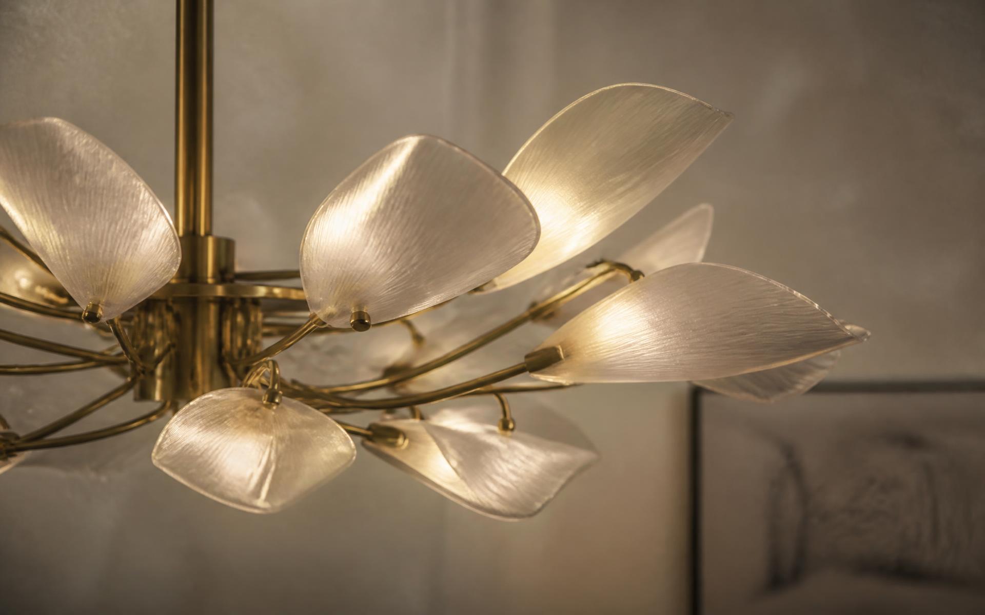 Sculptural brass chandelier with glowing petal diffusers